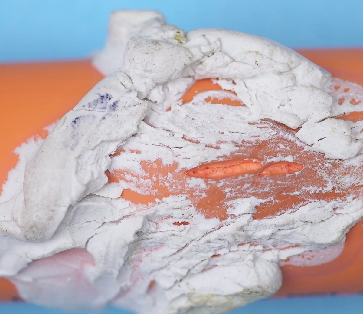 CPVC pipe showing severe plasticization damage — pipe wall softened and deformed by chemical contamination